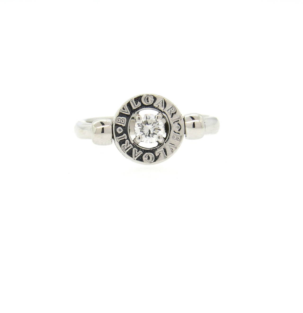 Bulgari 18k white gold flip ring, set with a 0.25ct diamond in the center. Ring is a size 6, top of the ring is 9.5mm in diameter. Marked Bvlgari,750, made in Italy. Weight of the piece - 5.2 grams
Retails for $3290