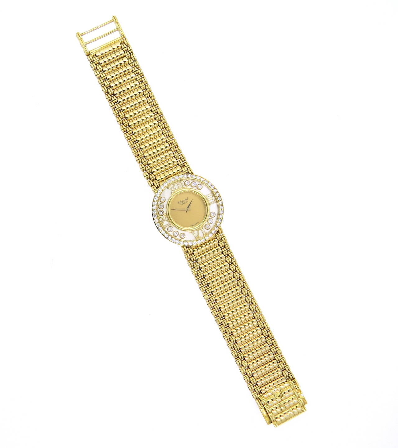 Unisex Impressive 18k yellow gold watch with quartz movement, set with diamond bezel, four diamond Roman numeral markers and twelve floating diamonds on the dial. Case is 32mm in diameter, 18k gold band is 7 1/2