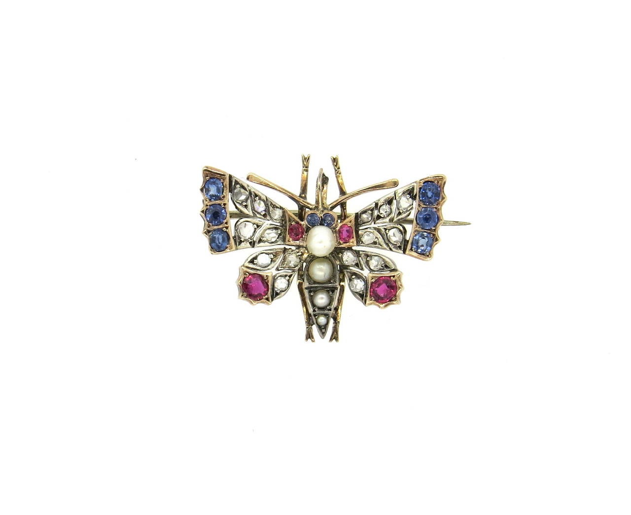 Antique 14k gold brooch pin, depicting a butterfly, set with rose cut diamonds, blue sapphires, rubies and pearls. Brooch measures 35mm x 28mm. Weight of the piece - 8.3 grams