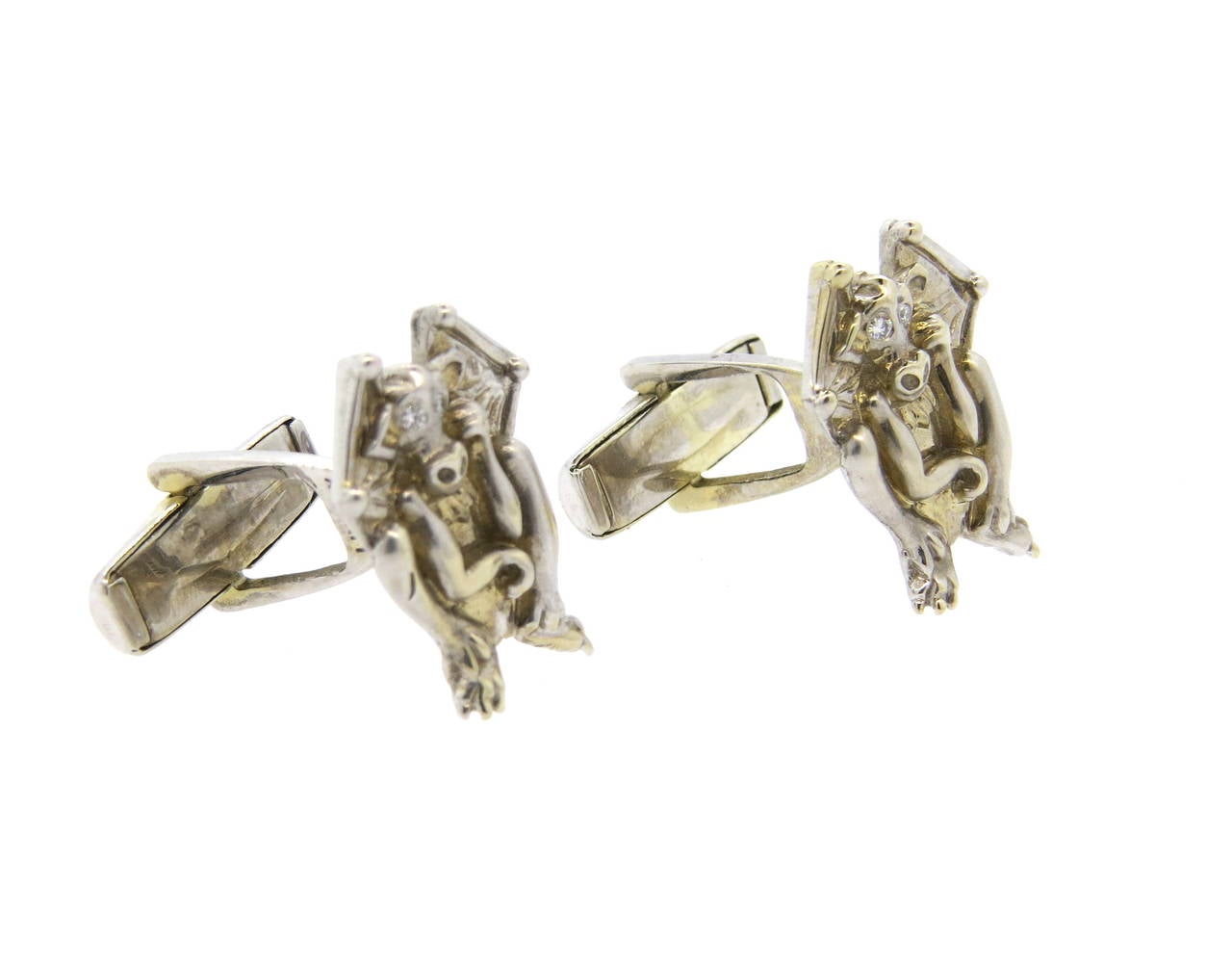Whimsical and unusual pair of 14k white gold cufflinks by Lindsay & Co, featuring mythical creatures - winged goblins with diamond eyes. Tops measure 21mm x 16mm. Marked Lindsay and 14k. Weight - 14.1 grams