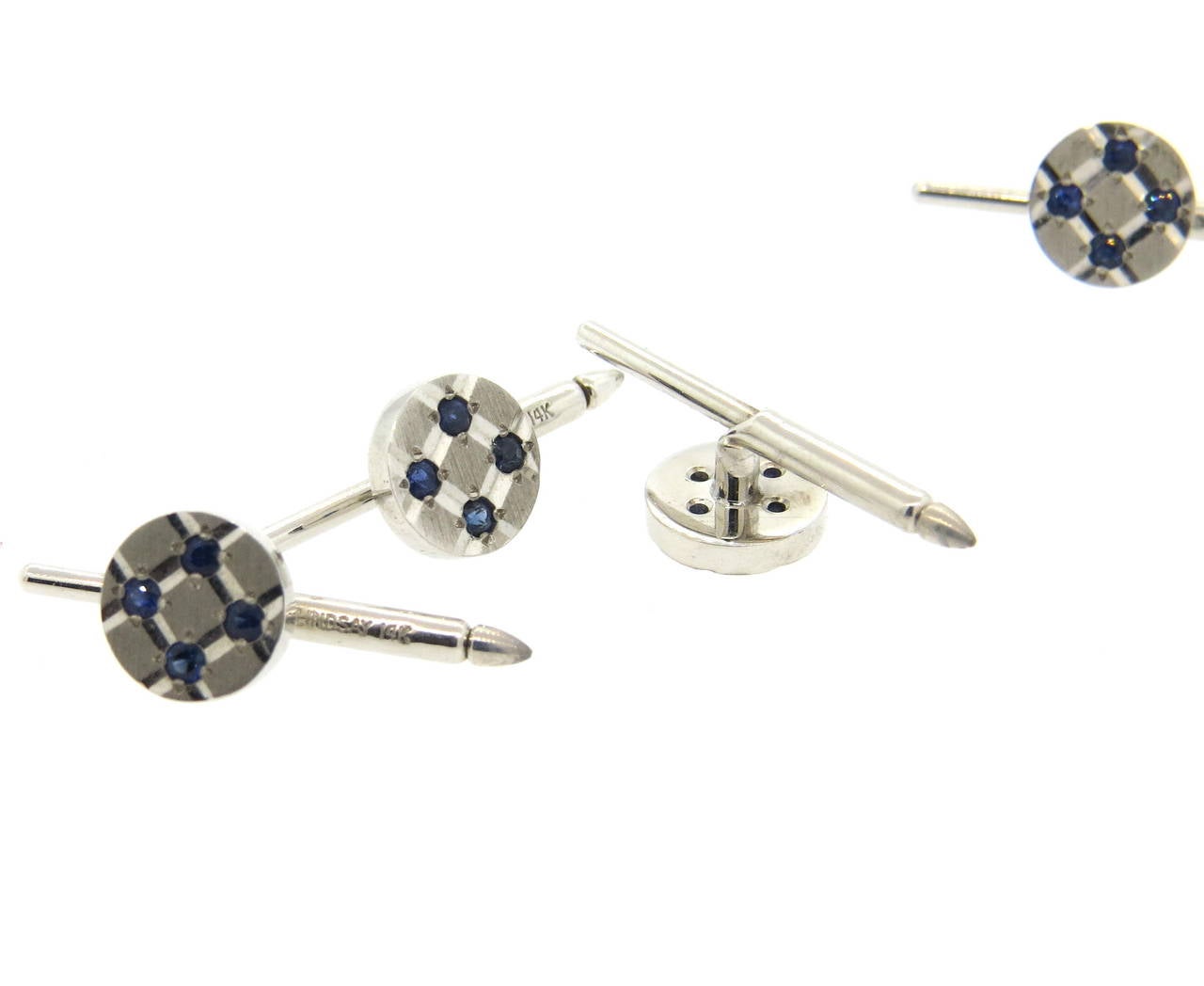 14k white gold dress stud set of 4, crafted by Lindsay & Co, decorated with blue sapphires. Each stud top measures 9.5mm in diameter. Marked Lindsay 14k. Weight of the set - 10 grams