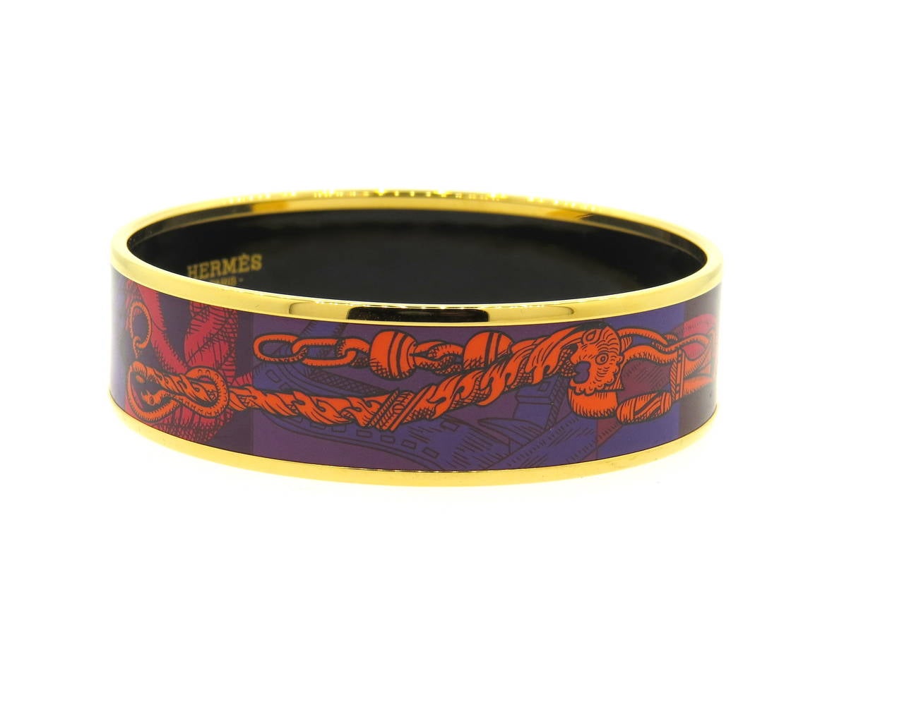 Modern gold tone bangle bracelet, crafted by Hermes, featuring printed enamel ornament. Bracelet's inner diameter is 62mm, bracelet is 18mm wide. Marked Hermes Paris, made in France + R. Weight of the piece - 35.8 grams
Comes with Hermes pouch and