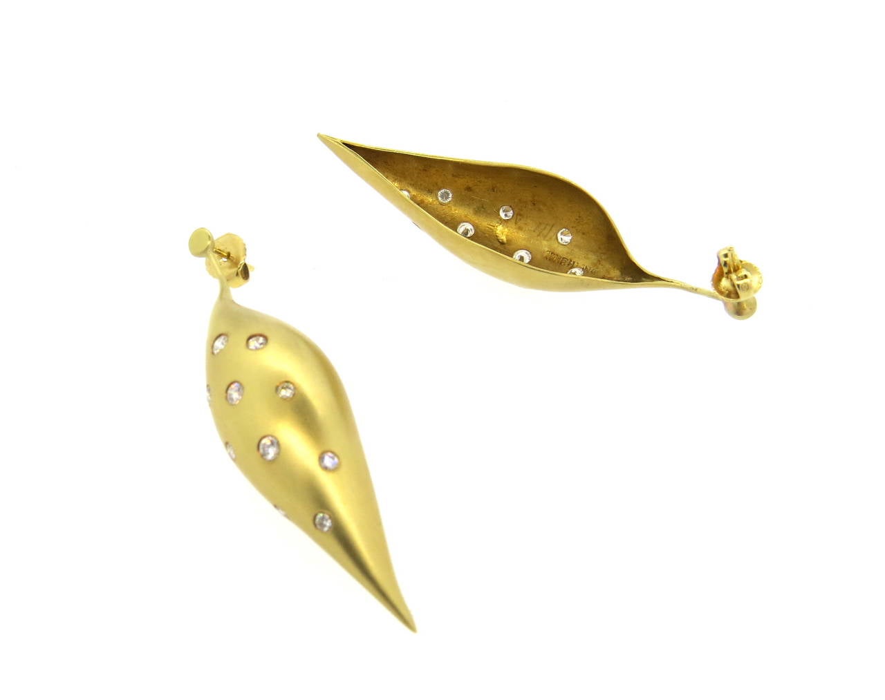 18k gold modernist earrings, crafted by Ted Muehling, decorated with approximately 0.60ctw in diamonds. Earrings are 57mm long x 14mm wide, backs are not original. Marked Muehling, 18k. Weight - 15.4 grams
