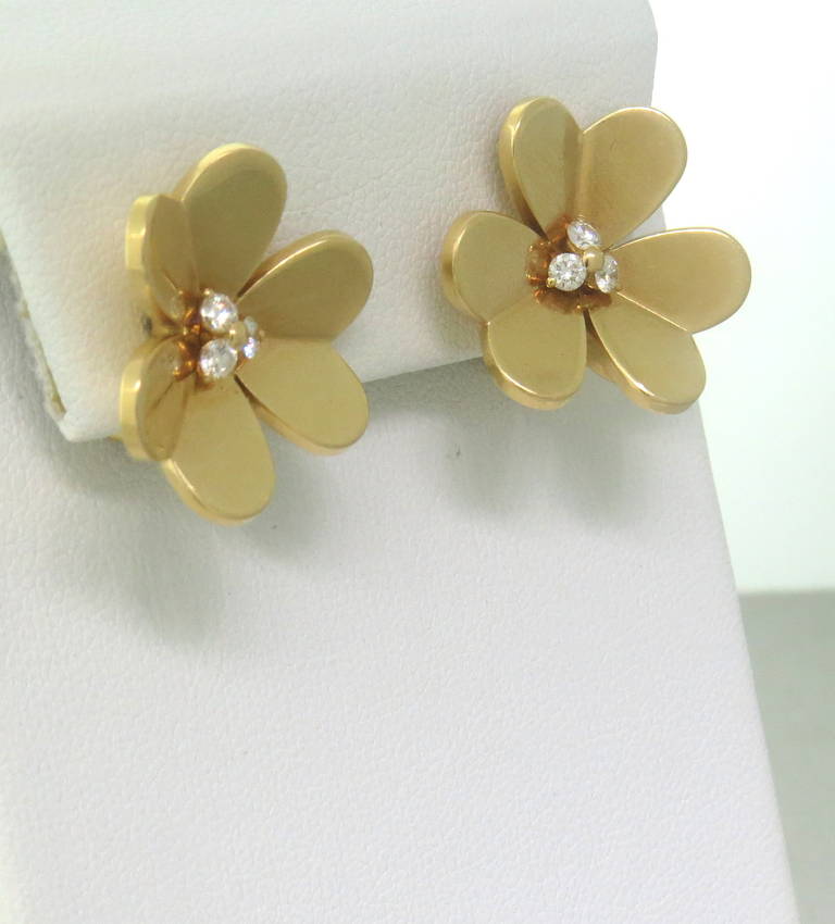 Van Cleef & Arpels Frivole Gold Diamond Flower Earrings in 18k yellow gold.  The earrings contain approximately 0.30ctw.  The earrings measure 22mm x 22mm and weigh 13.4 grams.  The current retail on these earrings is $6500.