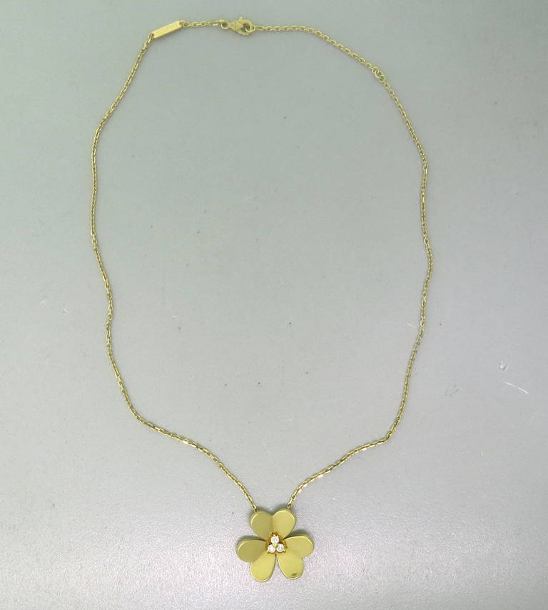 An 18k Yellow Gold Flower Pendant Necklace from the Frivole collection featuring approx. 0.15ctw in diamonds.  The necklace is 16