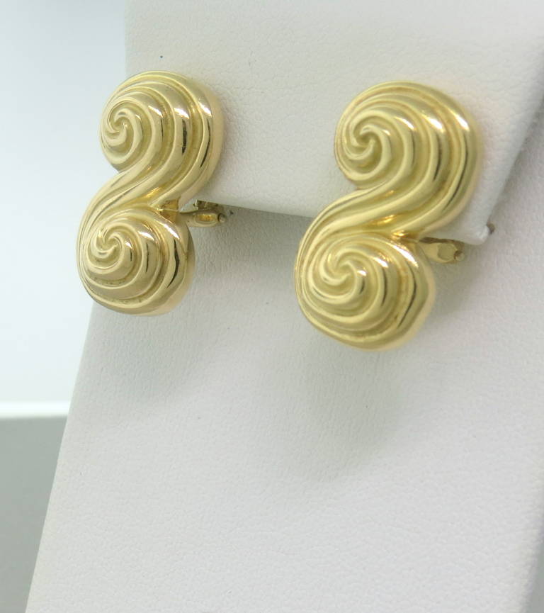 Classic swirl motif earrings by Tiffany & Co. Earrings are made of 18k yellow gold, with a weight of 19.6 grams.  The earrings measure 25mm x 16mm.