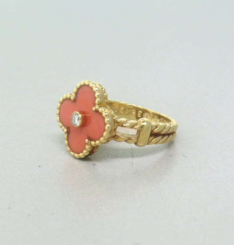 Van Cleef & Arpels Vintage Alhambra 18k Yellow Gold Coral and Diamond Ring in size 5.75.  The diamond is approximately 0.05ctw VVS clarity / F color.  The top of the ring measures 10.5mm x 10.7mm.  The ring weighs 7.7 grams.