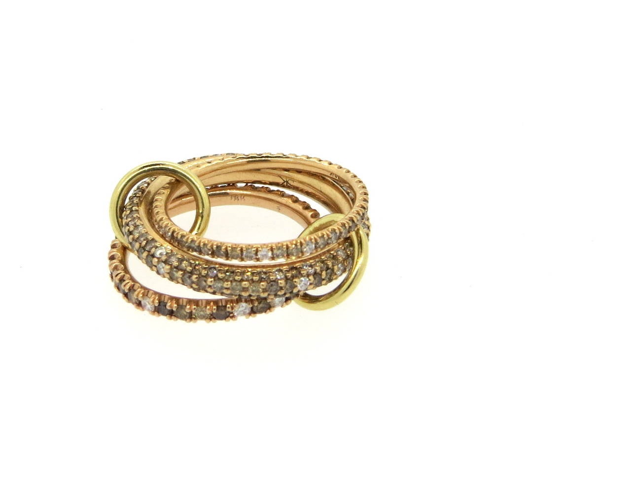 A set of three interlocked band rings, connected with small circles. Rings are set with a total of 2.80ctw in white, champagne and cognac diamonds. Rings make a size 8, and are approximately 8mm wide. Weight of the set - 11.5 grams
Retail for $8400