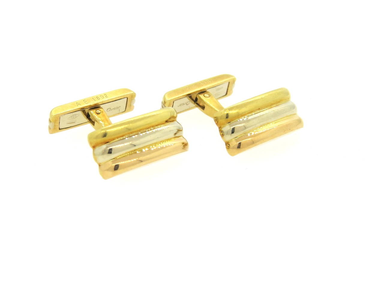 Classic Trinity Cartier cufflinks, set in 18k white, yellow and rose gold. Tops measure 18mm x 9mm. Marked Cartier, 1989, 750. Weight - 15.5 grams