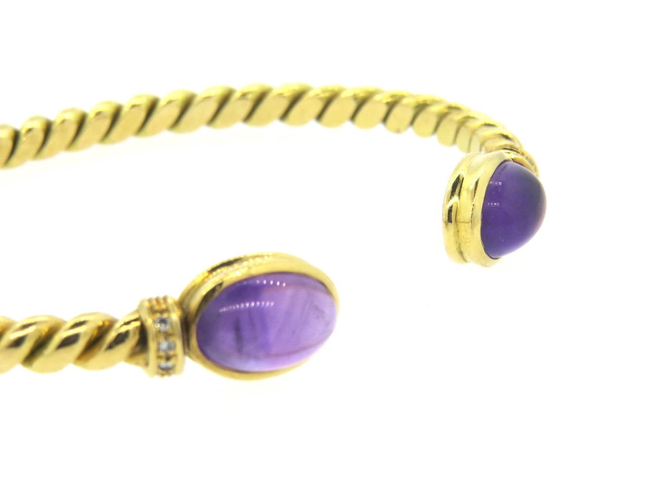 Vintage 1970s 18k gold cuff bracelet, decorated with diamonds and 11.8mm x 8mm amethyst cabochons. Bracelet will fit up to 7 1/2