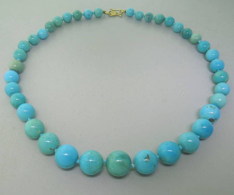 Turquoise Bead Necklace by Angela Carrubba Pintaldi with an 18k yellow gold clasp.  The turquoise beads measure between 8.8mm - 17.8mm in diameter. The piece is 21: Long and weighs 99.9 grams
