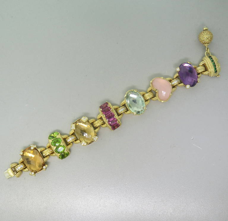 Large 18k gold bracelet by Judith Ripka set with amethyst, rose quartz, green quartz, olive quartz, pink tourmaline, peridot, tsavorite, citrine and approximately 0.80ctw in diamonds.  The bracelet is 7.25