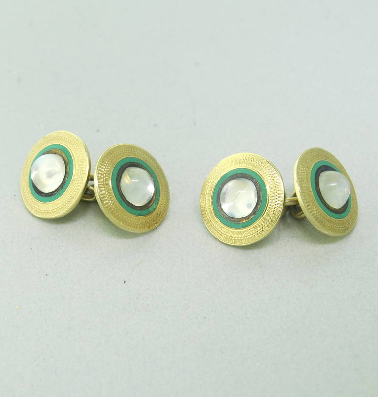 14k Gold Cufflinks adorned with green enamel and set with moonstones.  Cufflinks measure 14.4mm in diameter and weigh 9.9 grams.