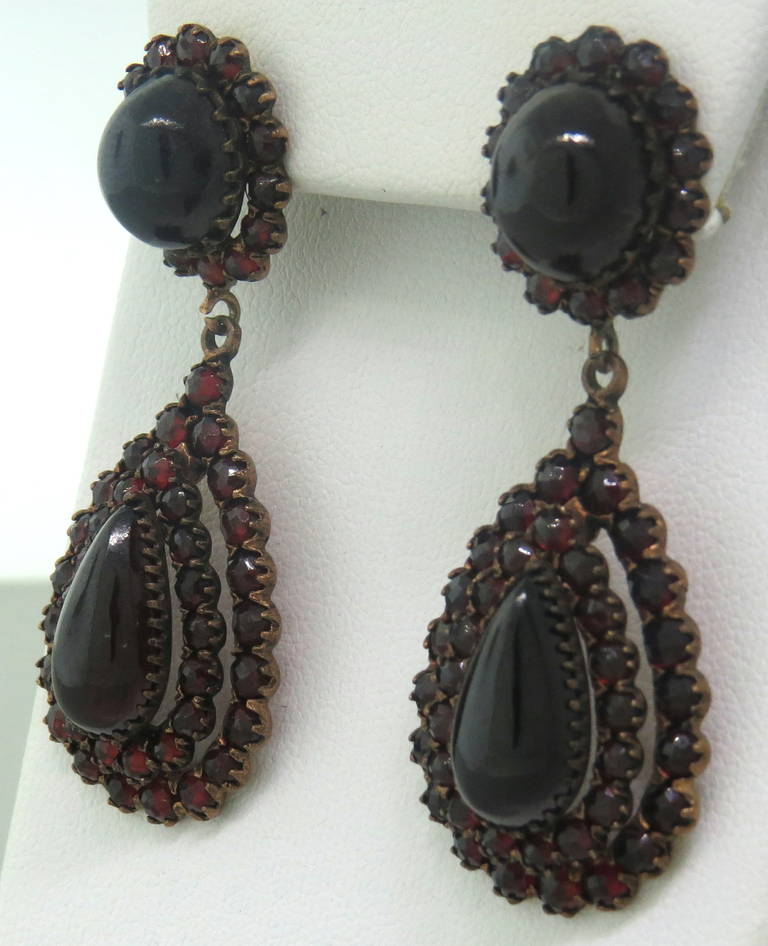 Antique earrings of gilt silver and low carat gold, set with bohemian garnets.  The earrings measure 53mm x 20mm and weigh 17.9 grams.