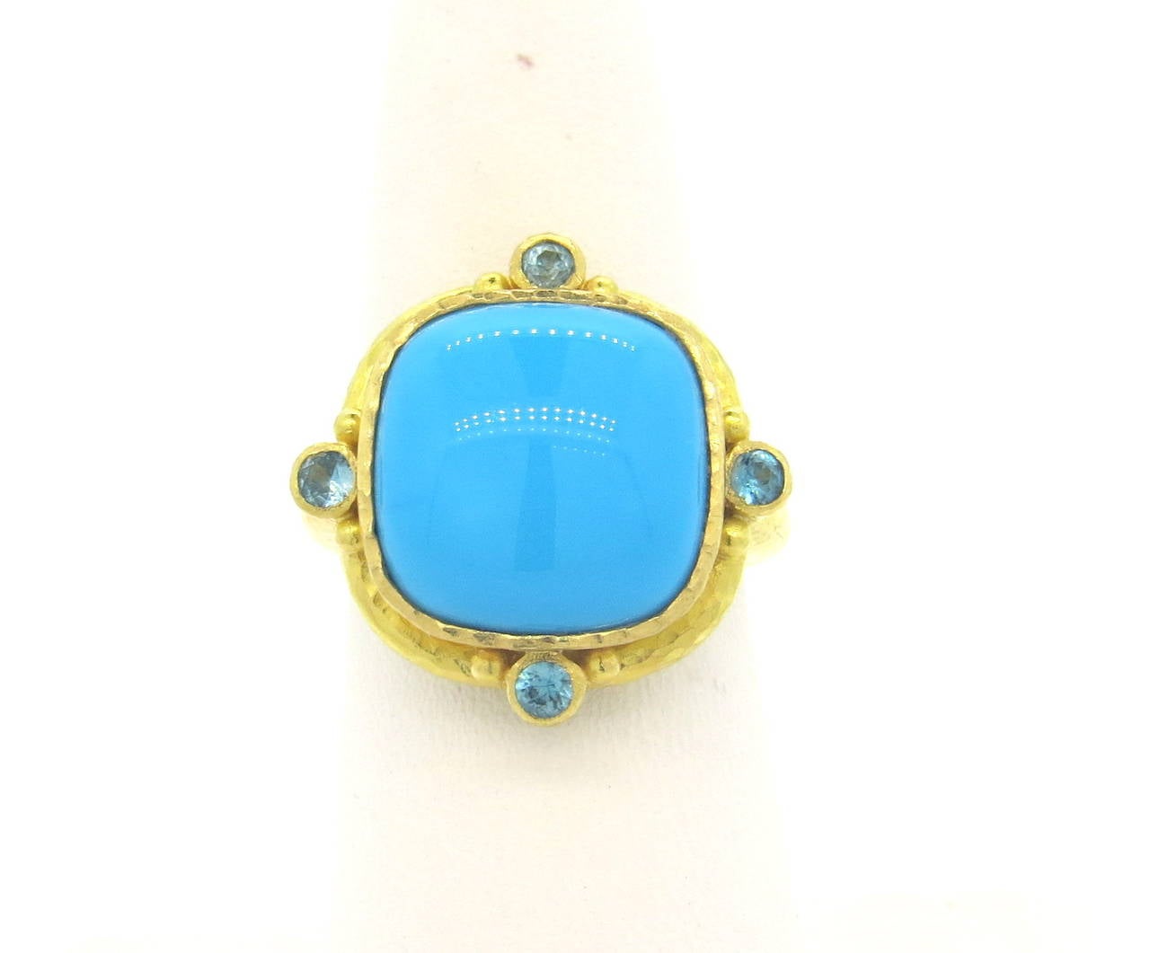Elizabeth Locke signature 19k yellow gold ring, set with 13.8mm x 13.8mm turquoise, surrounded with four blue gemstones. Ring is a size 6 3/4, ring top is 21mm x 21mm. Marked 19k and with Locke hallmark. Weight of the piece - 13.4 grams
