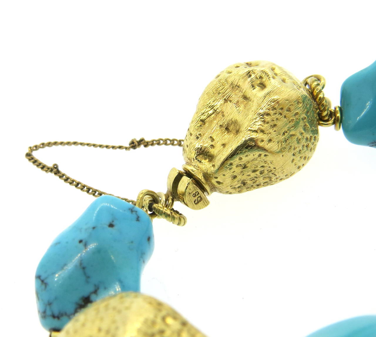 Spritzer & Furman 18k yellow gold bracelet, set with four turquoise stations. Bracelet is 8 1/2