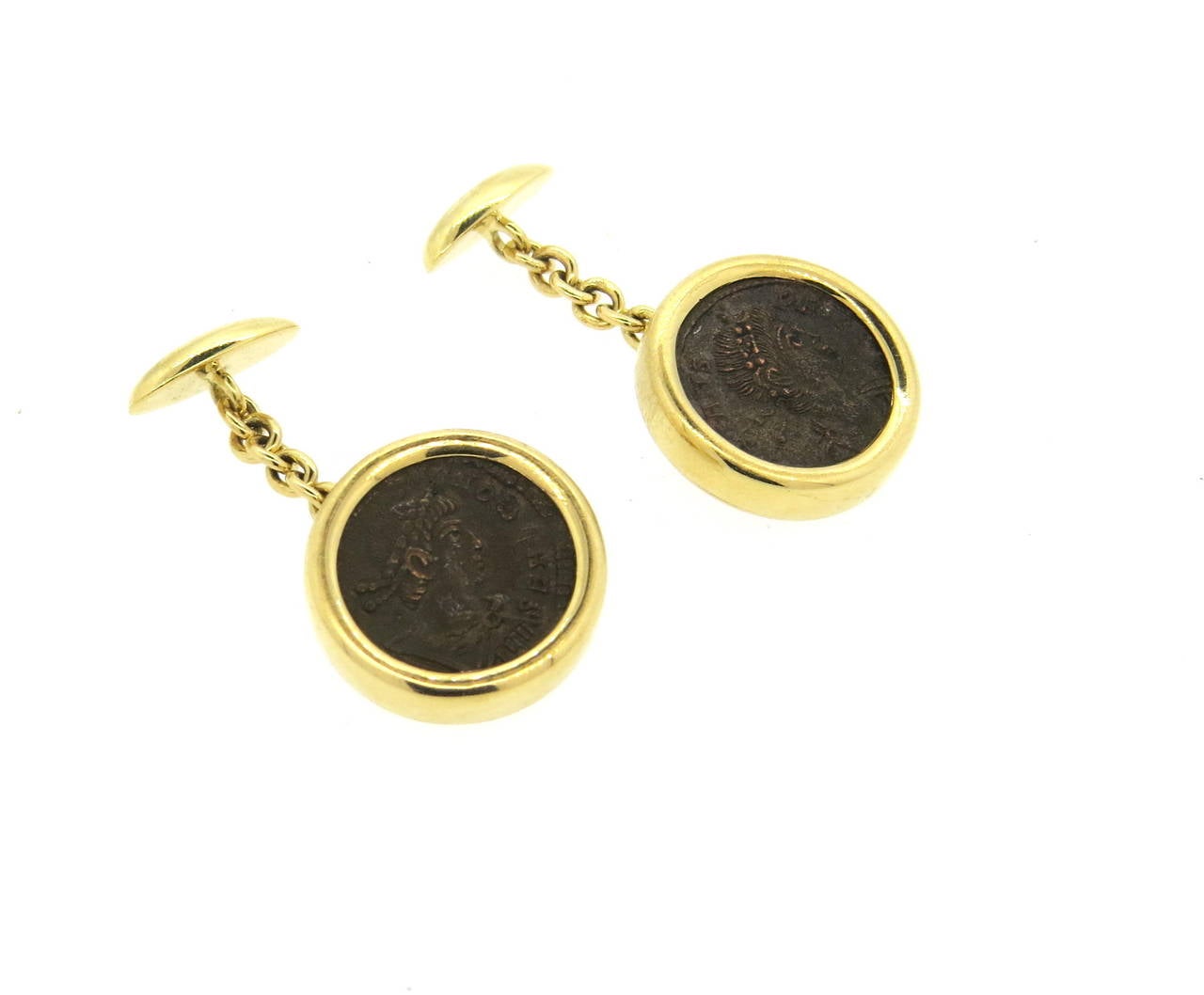 A pair of 18k yellow gold cufflinks, crafted by Bulgari for Monete collection, set with ancient coins in the center. Top of the cufflink measures 18mm in diameter. Marked Bvlgari, 750, Roma-Constantins I Avg A.D. 337-350. Weight - 19.1 grams