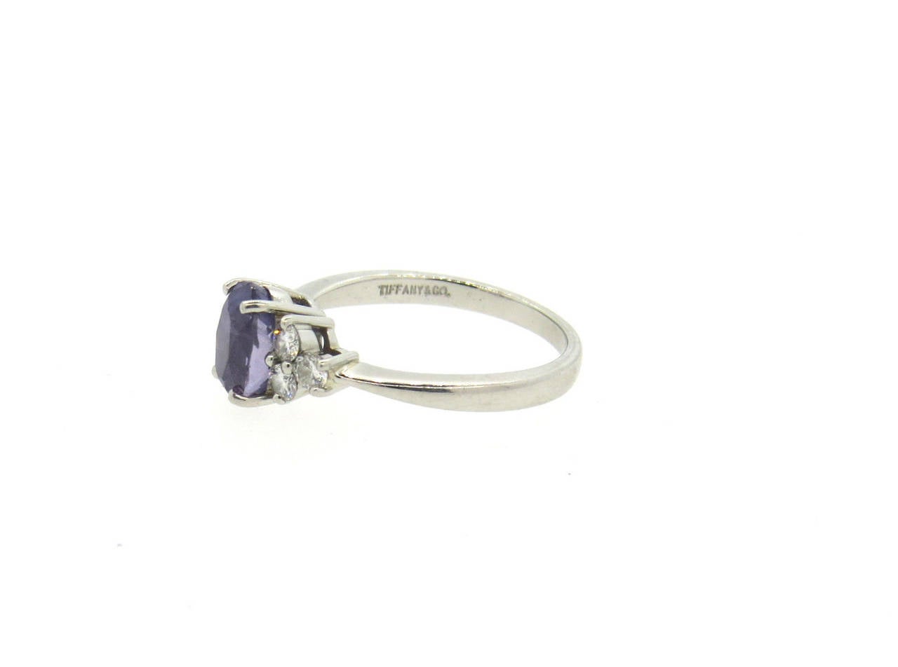 Platinum ring, crafted by Tiffany & Co, featuring 1.69ct color changing sapphire ( changing from purplish to violetish blue) , surrounded with 0.44ctw in VVS/VS-GH diamonds. Ring is a size 5 1/2, ring top is 7.8mm x 12.3mm. Marked Tiffany & Co,