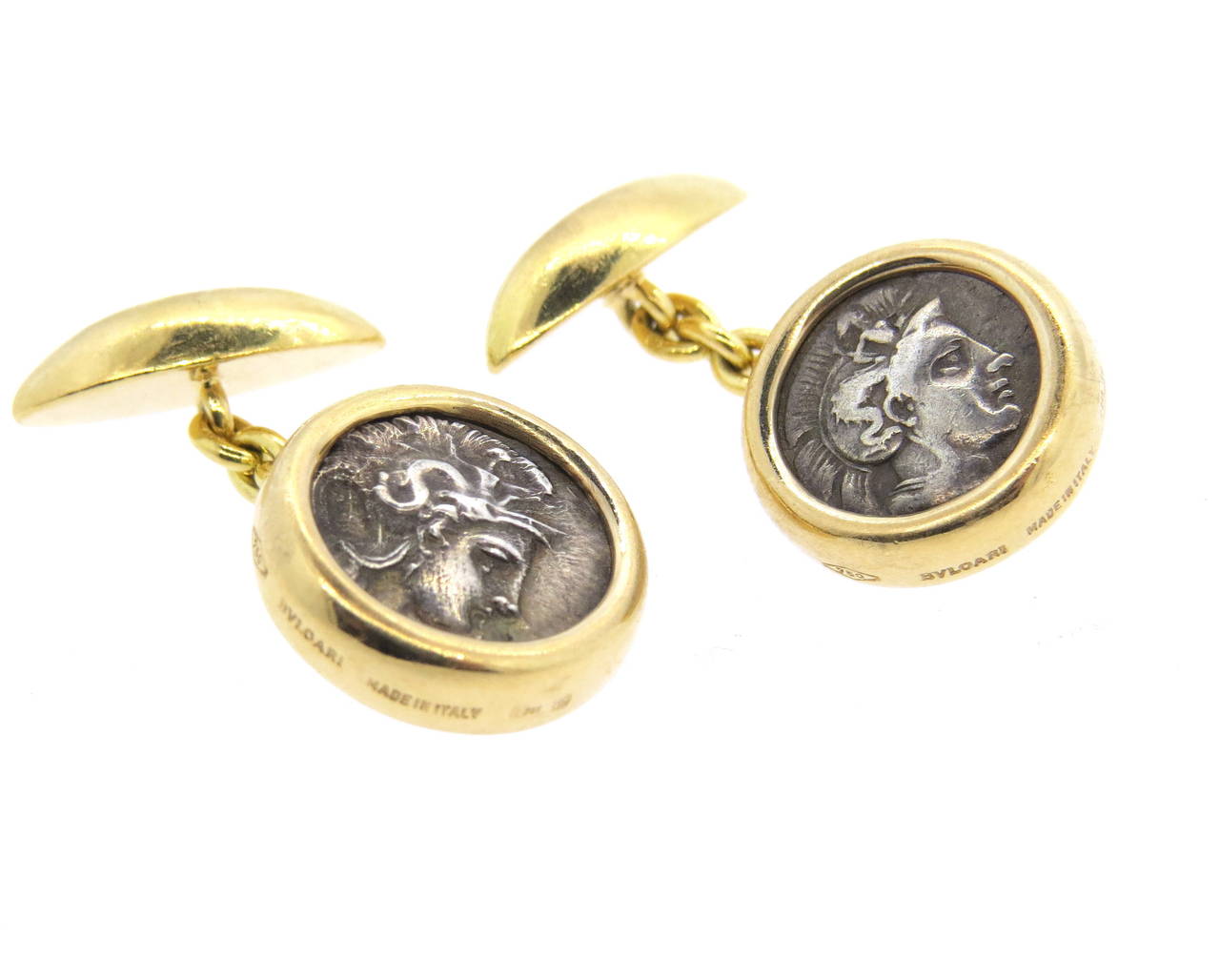 Pair of 18k yellow gold cufflinks, crafted by Bulgari, set with ancient coins in the center. Top measures 14mm in diameter. Marked Lucania-Thurion, 4th cent B.C., Calabria-Tarentum, made in Italy, 750, Bvlgari. Weight - 19 grams.