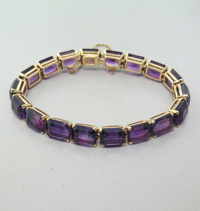 A mid century 14k gold bracelet, set with approximately 51 carats of Amethyst.  The bracelet is 7