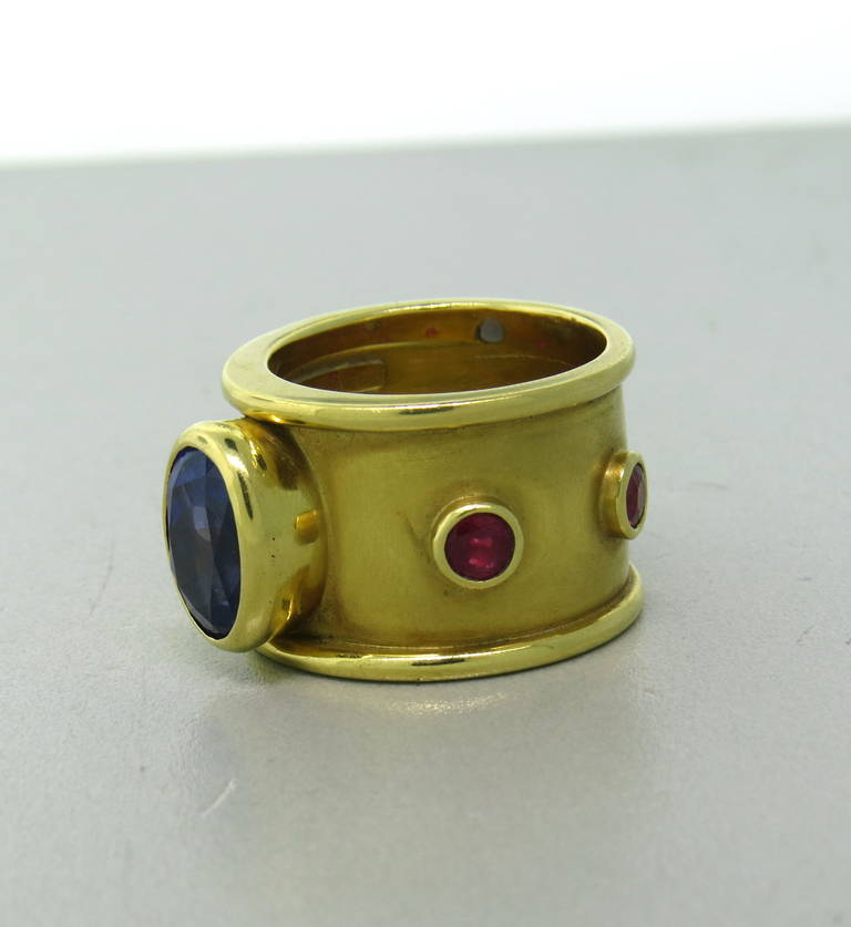 Mish New York 18k gold ring set with a 5 carat tanzanite and rubies.  The ring is a size 9.25 and is 16.3mm wide.  The piece weighs 24.4 grams.