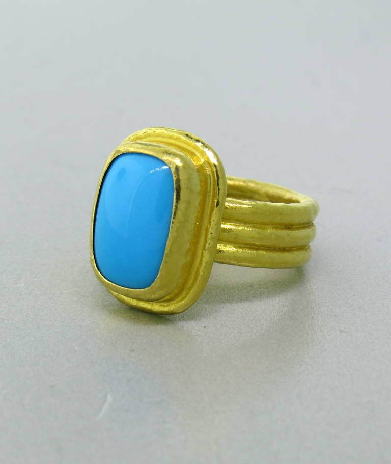 Ara 24k gold ring set with a 12.7mm x 8.5mm turquoise.  The ring top of the ring measures 18mm x 14mm and the shank is 6.4mm wide.  The ring is a size 6 and weighs 10.0 grams.