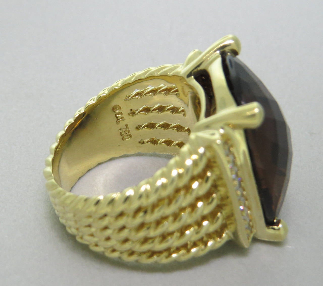 Beautiful David Yurman 18K yellow gold Wheaton ring featuring a large smokey quartz decorated with approx. 0.24ctw of H/VS diamonds. Ring size 7, ring top is 20mm x 17mm.  The weight of the piece is 20.7 grams.