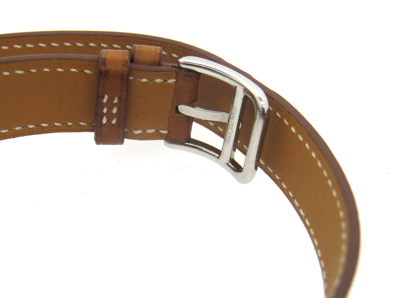Stainless steel tonneau shape watch, crafted by Hermes for Cape Cod collection with classic wrap around brown leather bracelet (comes with an extra new one) Case measures 33mm excl crown x 42mm lug tip to lug tip.  Ref. CT1.710. Quartz battery
