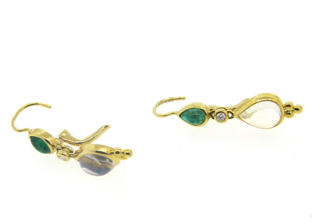 A pair of new 18k yellow gold drop earrings, crafted by Temple St. Clair, set with emerald and moonstone cabochons and 0.07ctw in G/VS diamonds. Earrings 35mm x 8mm. Marked with Temple mark and 750. Weight - 5 grams
Retail for $3000