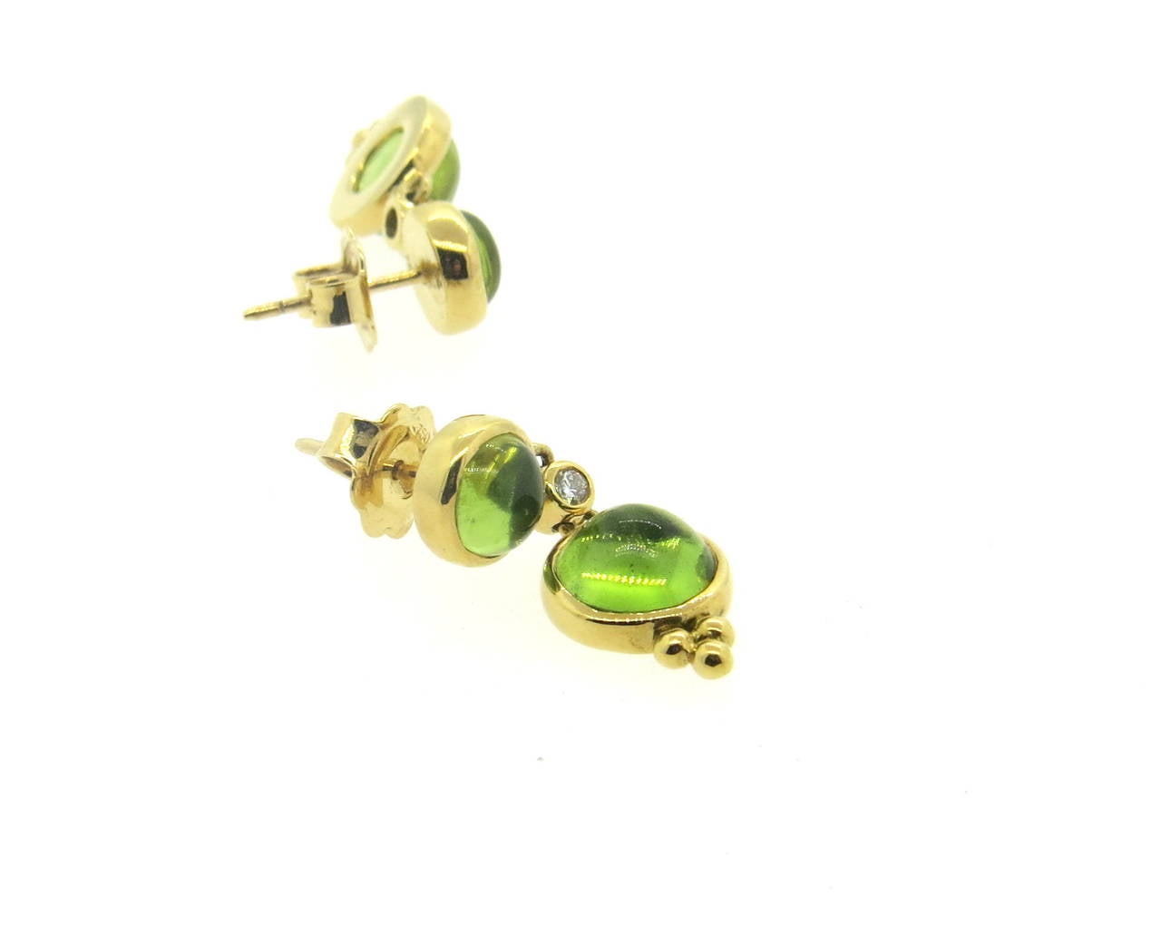 A pair of new 18k yellow gold drop earrings, crafted by Temple St. Clair, set with peridot cabochons and 0.06ctw in G/VS diamonds. Earrings are 26mm x 10mm. Marked with Temple hallmark and 750. Weight - 6.3 grams
Retail for $2750