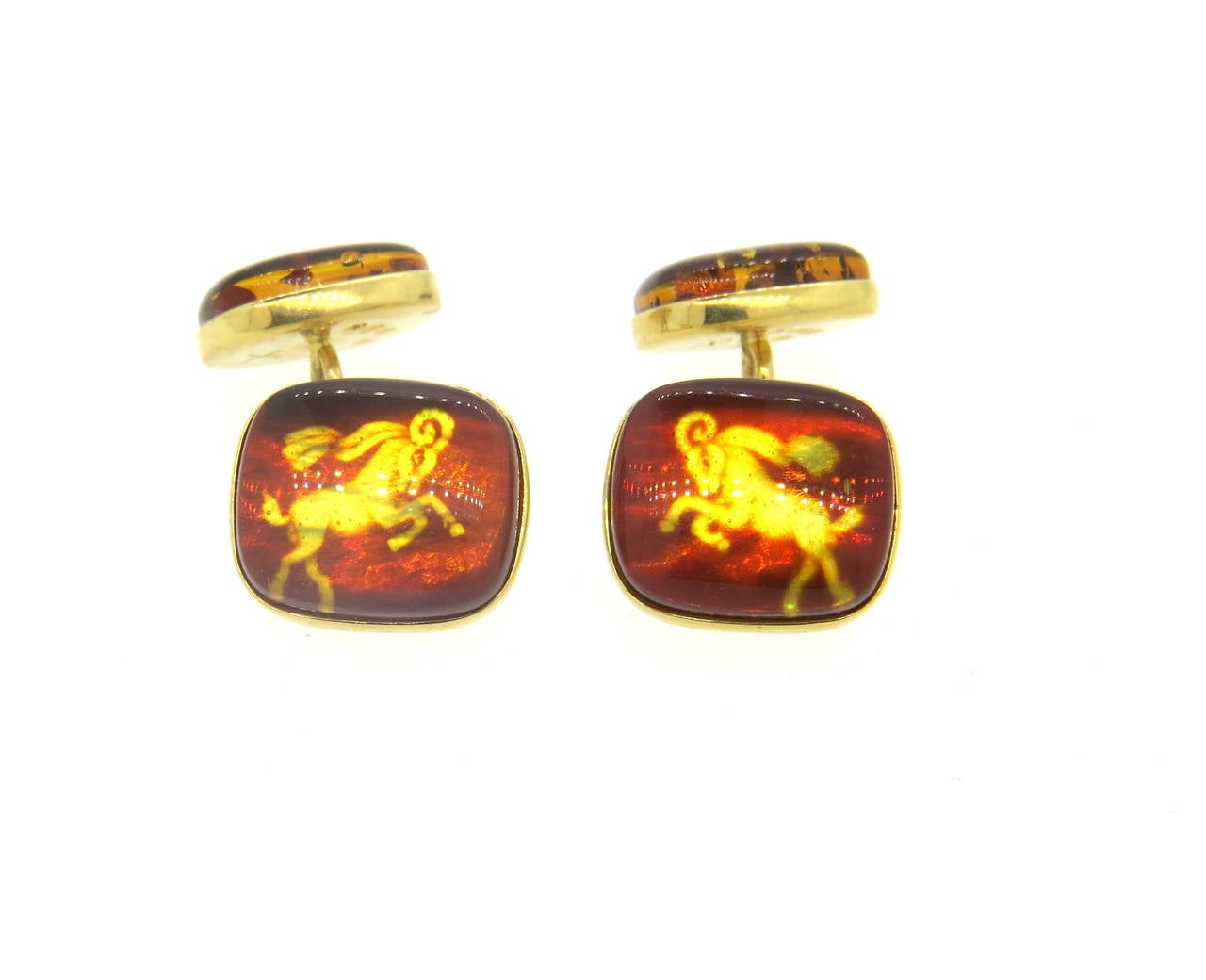 A pair of 18k yellow gold cufflinks, crafted by Trianon, featuring amber gesmtones with Capricorn zodiac sign. Tops measure 15mm x 13mm, back - 13mm x 11mm. Marked Trianon, 750. Weight - 8.2 grams
Retail $3000