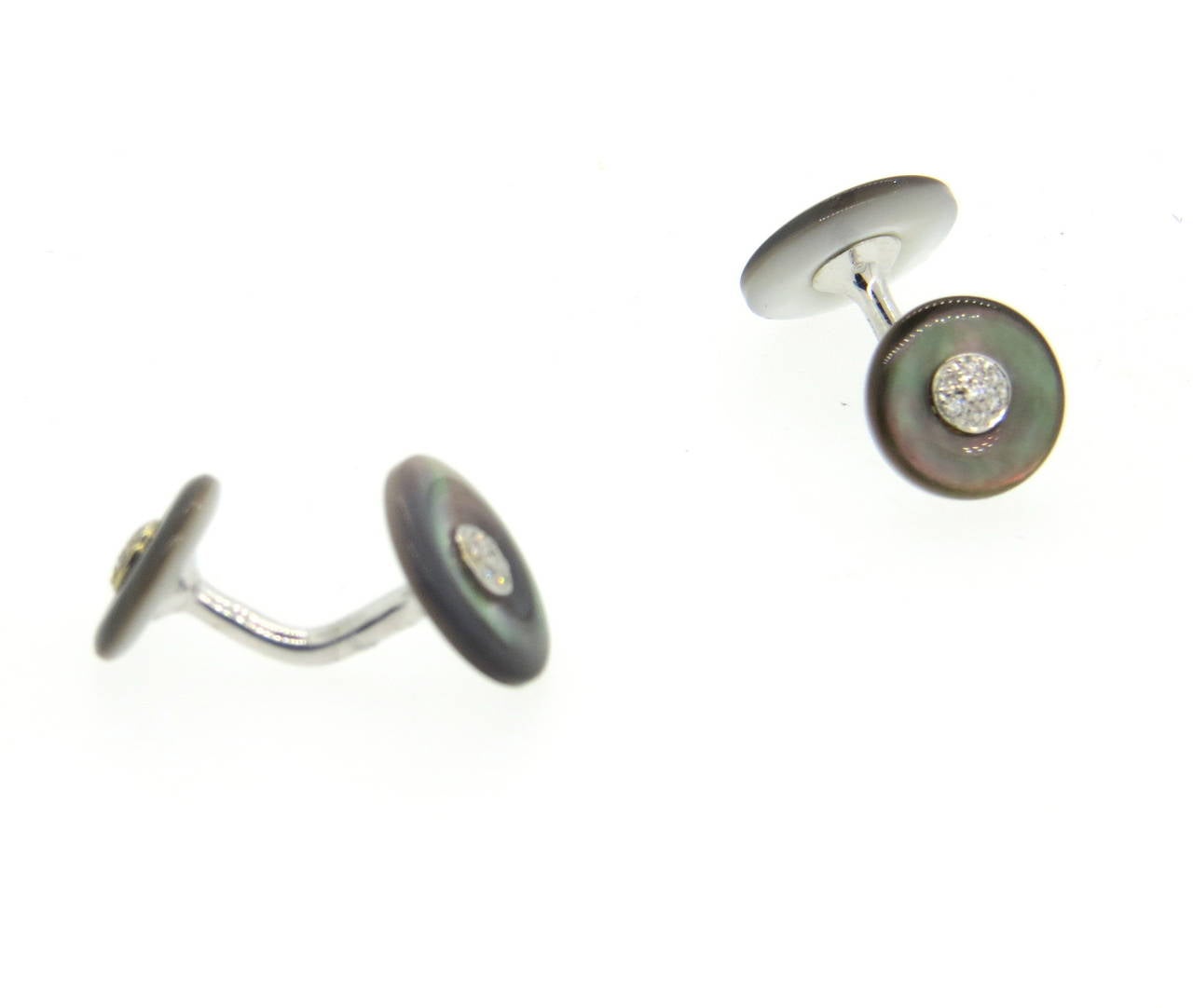 Pair of new 18k white gold cufflinks, crafted by Trianon, set with black mother of pearl top and diamonds in the center. Top of the cufflink measures 13mm in diameter, back - 11mm in diameter. Marked Trianon.  Weight - 5.3 grams
Retail $2000