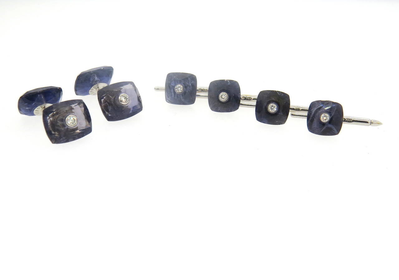 18k white gold dress set, includes a pair of cufflinks and four shirt studs, crafted by Trianon. Decorated with faceted iolite tops and diamonds in the center. Cufflink top measures 13mm x 12mm, stud top - 10mm x 10mm. Marked Trianon and 750. Weight