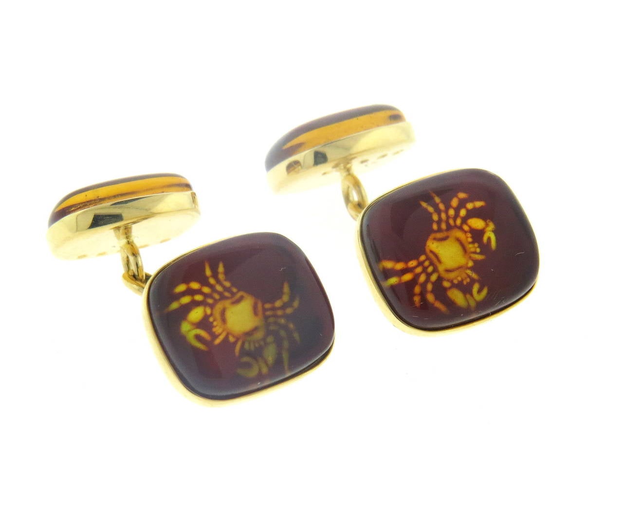 Pair of new 18k yellow gold cufflinks, crafted by Trianon, featuring amber top, depicting Cancer zodiac sign.  Top measures 15mm x 13mm, back - 14mm x 11mm. Marked 750, Trianon. Weight - 8.1 grams
Retail $3000