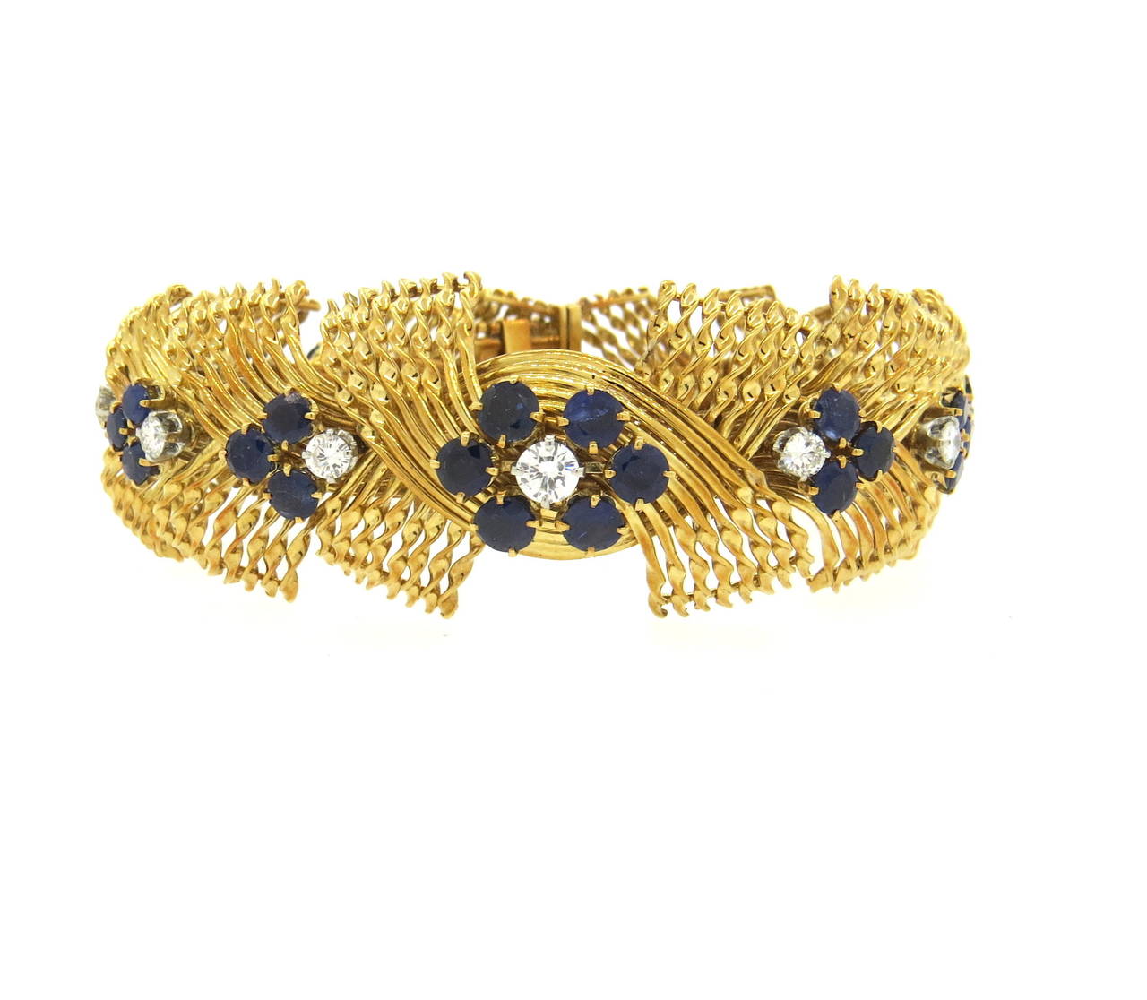 Impressive 18k yellow gold French bracelet, crafted in circa 1960s, set with blue sapphires and approximately 1.80 --2.00ctw in G/VS diamonds. Bracelet is 6 7/8