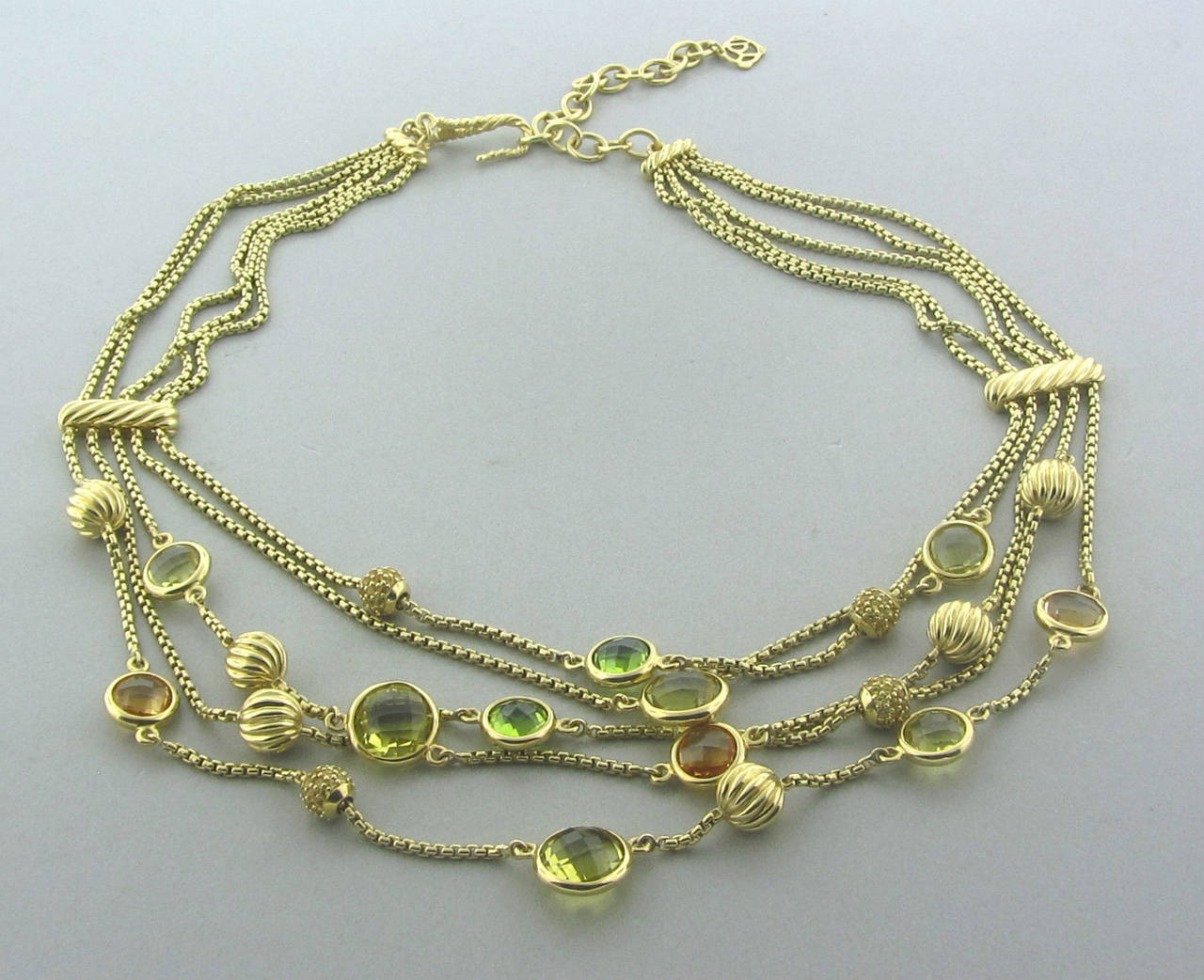 Attractive David Yurman multi strand 18K yellow gold necklace featuring Citrine, Peridot and Lemon Citrine gemstones. 17