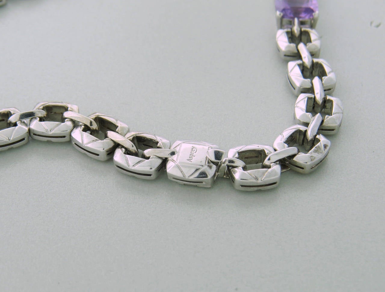 An 18K white gold necklace features topaz, amethyst and tourmaline. Necklace is 16 3/4