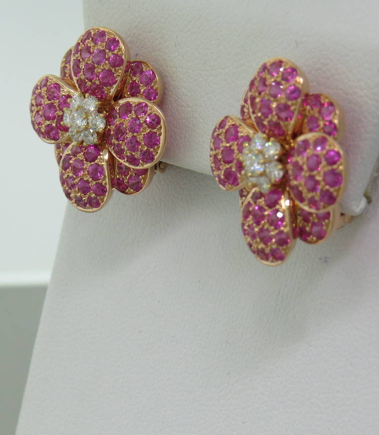 Delicate 18k gold flower earrings by Van Cleef and Arpels,featuring pink sapphire flower petals and diamonds in the center. Earrings measure 22mm x 22mm.  weight  19.4gr, French hallmarks