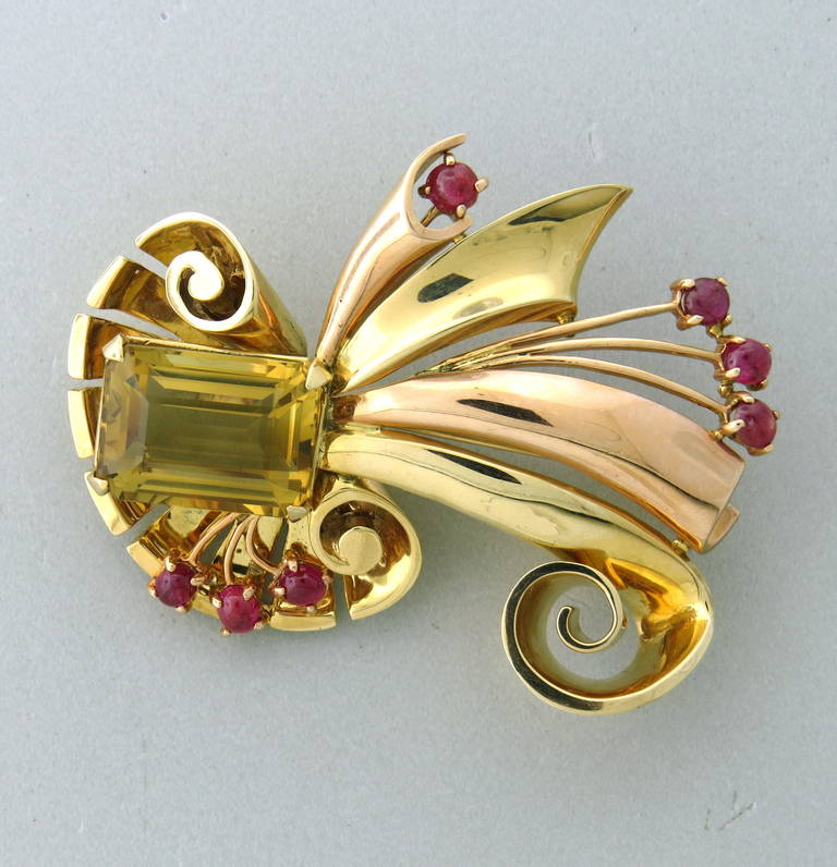 A retro brooch from the 1940s consisting of 14k yellow and rose gold, set with ruby cabochons and a citrine weighing approximately 15.5ct.  The brooch measures 61mm x 54mm.  The brooch weighs 31.5 grams.