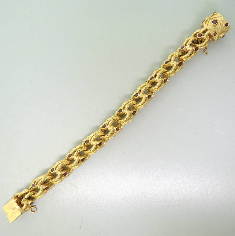 A 19k gold bracelet with Portuguese gold marks for 19k gold, set with garnets.  The bracelet measures 8.5