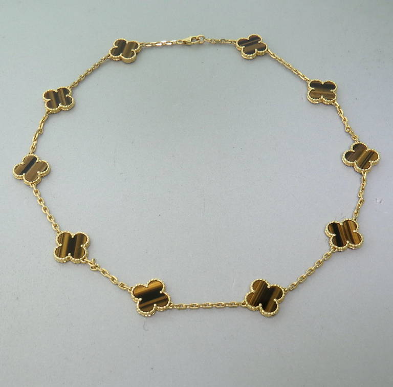 An 18k yellow gold necklace from the Vintage Alhambra collection by Van Cleef & Arpels.  The necklace is set with 10 tiger's eye clover motifs.  The necklace is 16.5