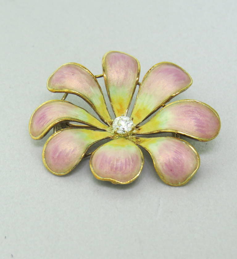 An Art Nouveau 14k gold pansy brooch pin with enamel.  The pin is set with one diamond, weighing approx. 0.12ctw.  The pin measures 33mm x 26mm and weighs 6 grams.