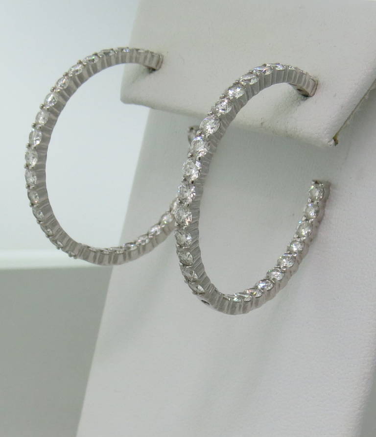 A pair of 18k white gold hoop earrings by Kwiat, set with approximately 5.80ctw in G/VS diamonds.  The hoops are 36mm in diameter and weigh 13.06 grams.