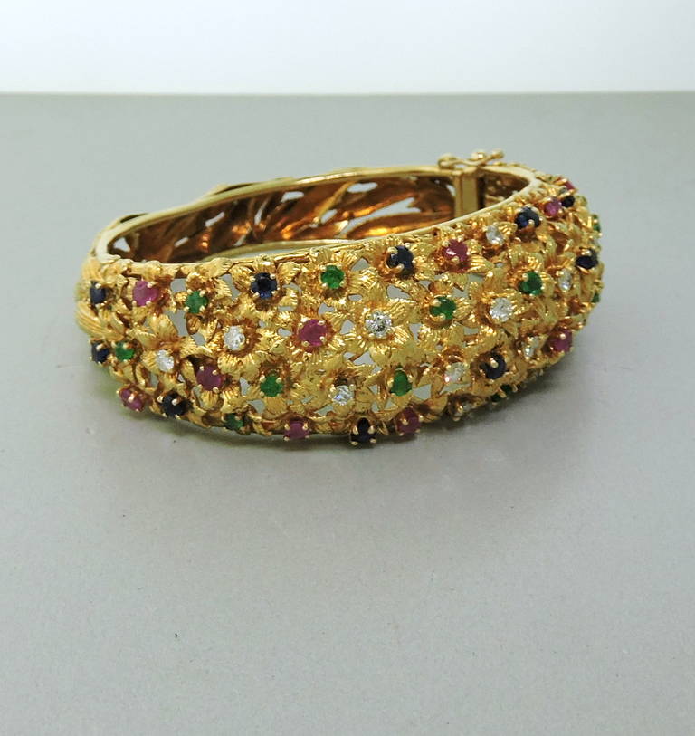 Stunning 18K yellow bracelet by Van Gogh featuring rubies, sapphires, emeralds and approx. 0.80ctw of diamonds. Diamond color G/H, Clairty VS1/SI1. Bracelet will fit up to 7