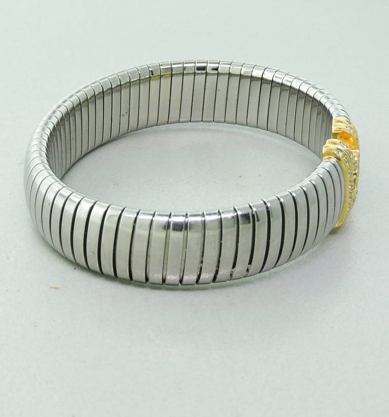 18K White and Yellow gold 'Parentesi' cuff bracelet by Bvlgari. Bracelet features approximately 0.20ctw of VS/G diamonds. Cuff is 12mm wide, ends measure 14mm wide. Bracelet will fit up to 6.5