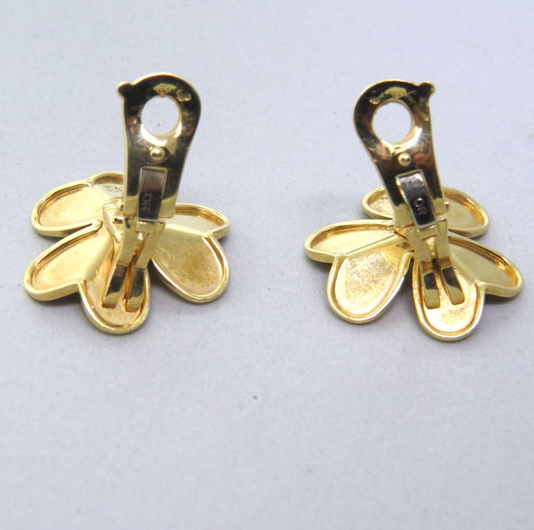 Van Cleef & Arpels Frivole Gold Diamond Flower Earrings in 18k yellow gold. The earrings contain approximately 0.30ctw. The earrings measure 22mm x 22mm and weigh 13.7 grams. The current retail on these earrings is $6500.
