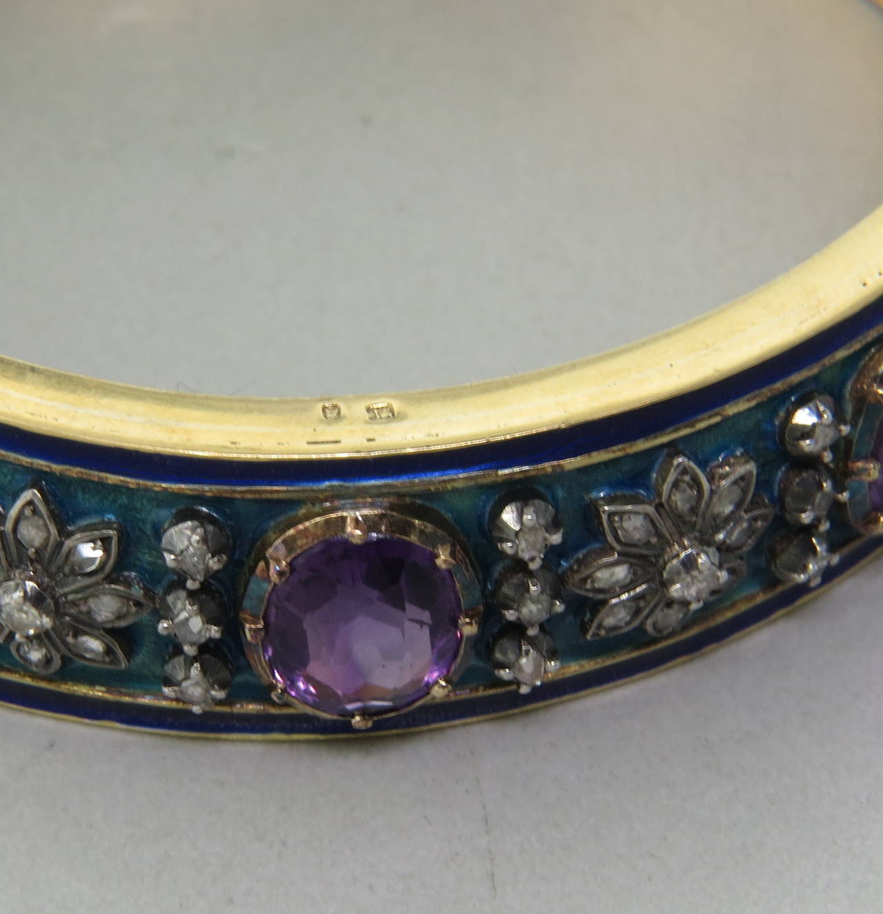 A hand engraved 18k yellow gold bracelet from the Victorian era, set with rose cut diamonds and amethyst and enamel.  The bracelet comfortably fits up to a 7