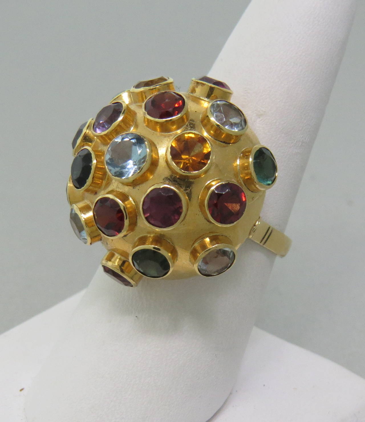 Ring size is 8 1/2, ring top is 24mm in diameter. Multi color semi precious gemstones. Marked 750. weight - 7.4g