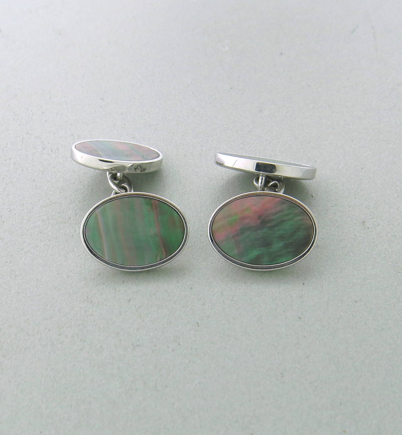 Trianon 18k gold oval cufflinks with black mother of pearl top, measuring 15mm x 11mm. weight - 9.8gr.