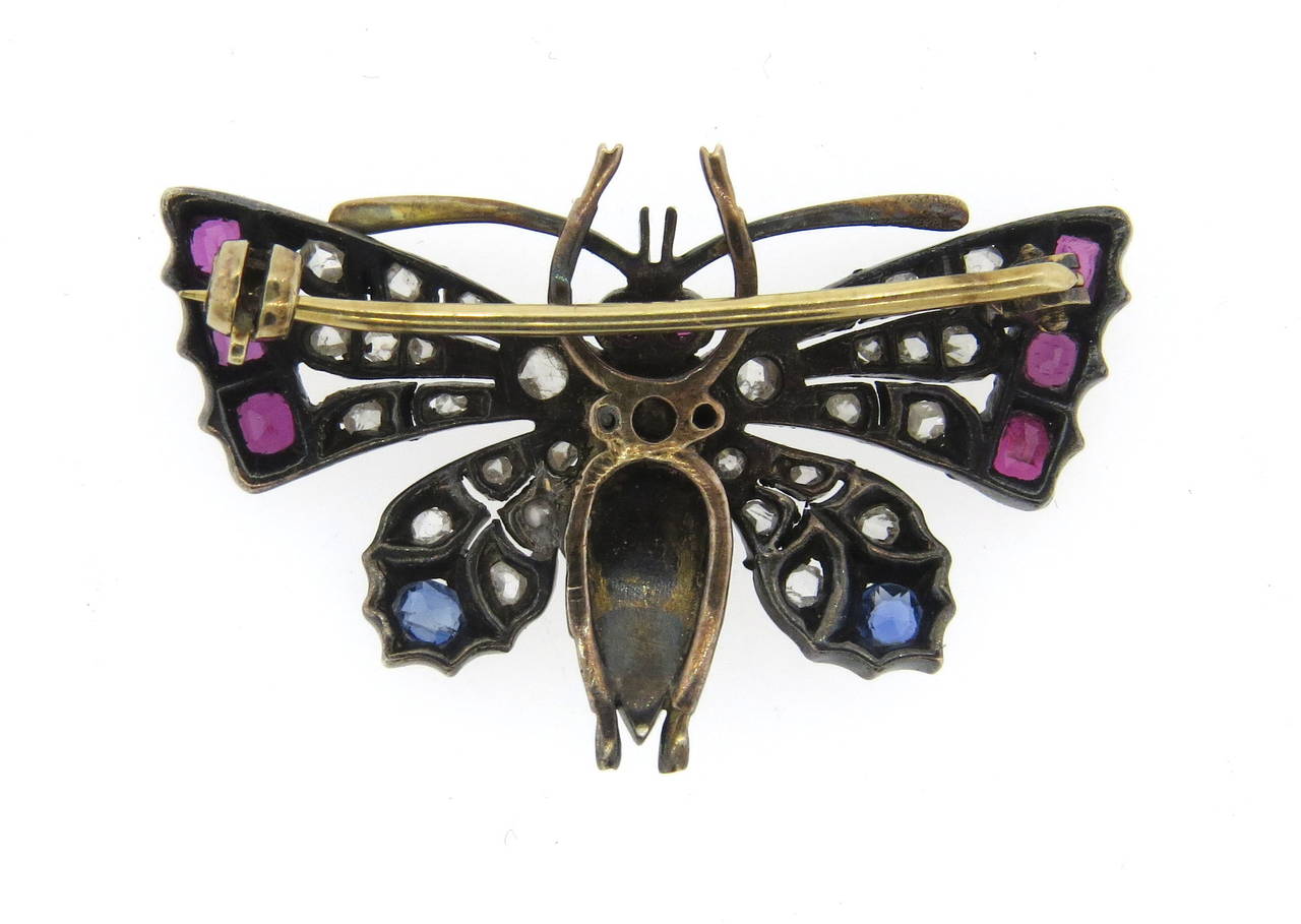 Antique butterfly brooch in gold and silver top, featuring pearls, rose cut diamonds, sapphires and rubies. Weight - 6.9gr